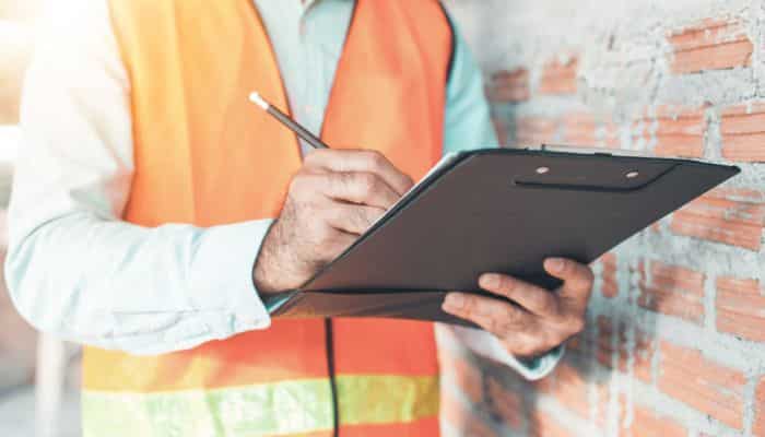 Real estate agent reviewing a pre-listing inspection report of a home in Charlotte, NC